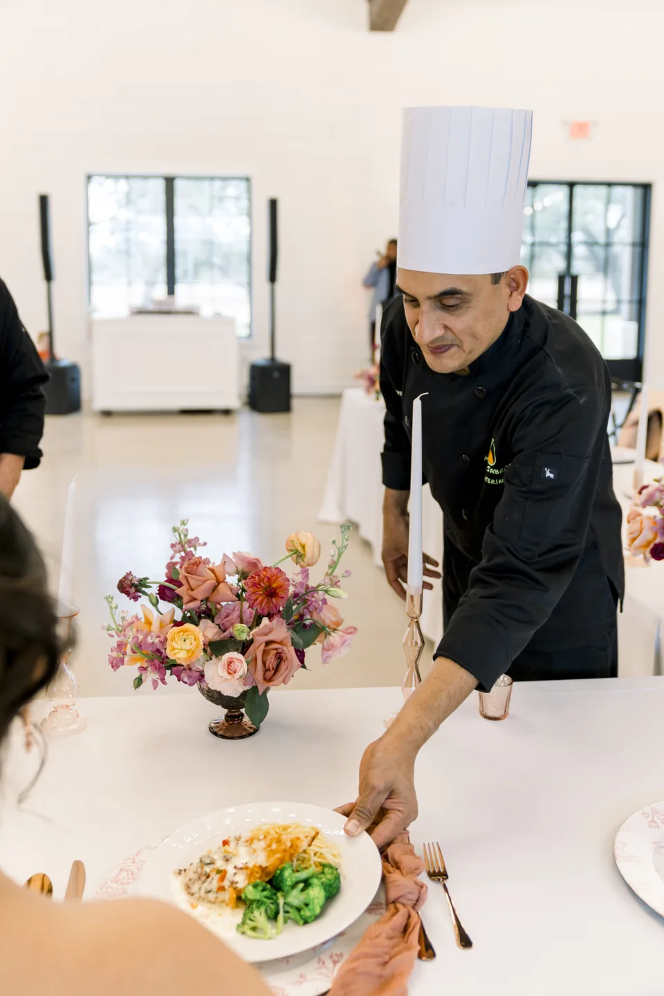 Chef Javier placing a finished meal on the table
